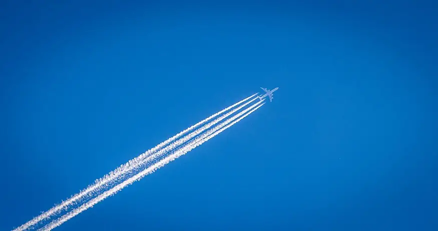 Airplane contrails - Airplane leaving trail in blue sky