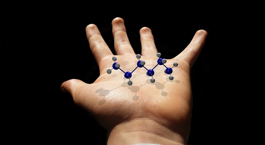 Pure Liquid Fuels - Hand holding molecules - science