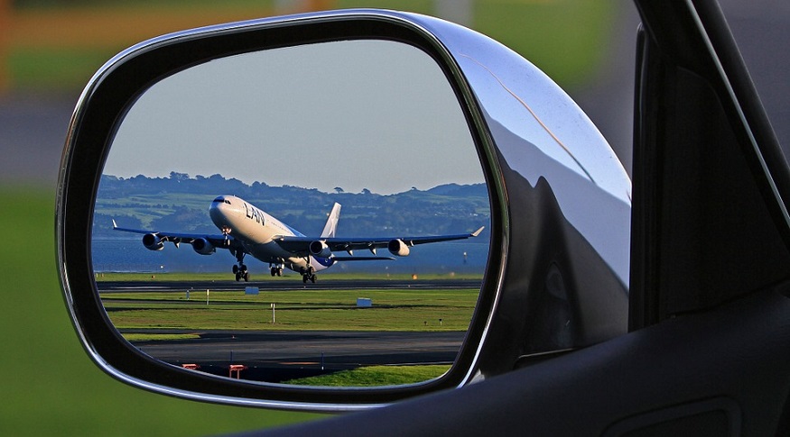 Hydrogen planes - plane taking off seen from car side mirror