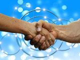 Blue hydrogen partnership - handshake- blue background