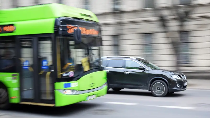 fuel cell buses - green bus travelling on road