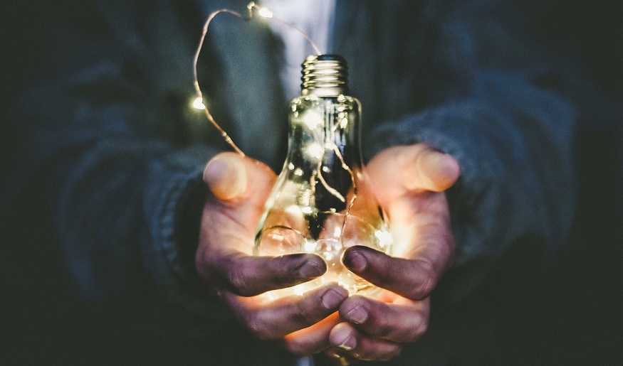 Clean electricity - Light bulb in hands