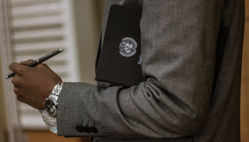 UN Sustainable Development Goals - Man holding folder with UN symbol