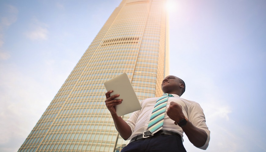 Solar to hydrogen - man celebrating success - building - sunshine