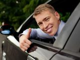Hydrogen car - person giving thumbs up out car window