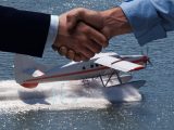 H2 amphibious aircraft - Image of a regular sea plane on water and handshake