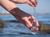 Seawater Electrolysis - Person putting ocean water in jar