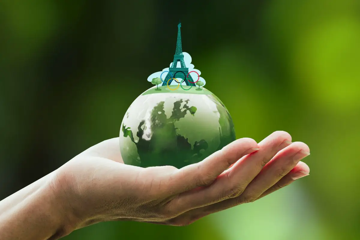 Sustainable Olympics - Person Holding green globe with Eiffel Tower