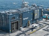 The Pentagon is field-testing EHOSS, a containerized hydrogen fueling unit built by Pratt Miller, to support unmanned systems and tactical energy autonomy—targeting a 2025 rollout.